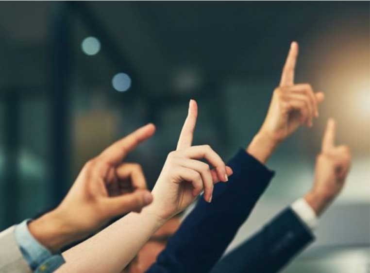 A set of raised hands trying to get attention